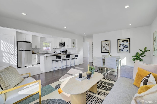 living area with recessed lighting and light wood-style flooring