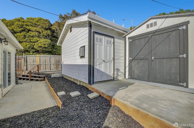 view of shed featuring fence