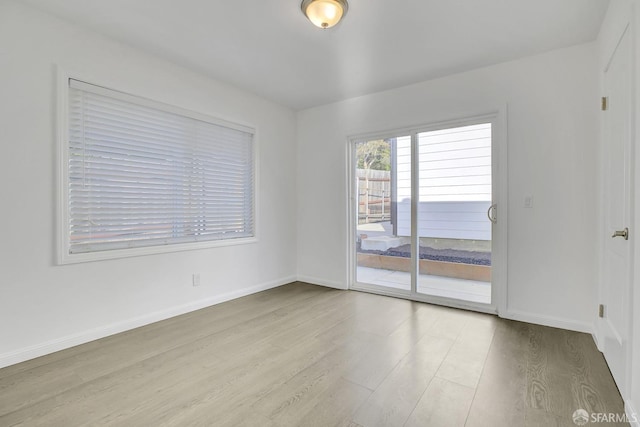 unfurnished room featuring wood finished floors and baseboards