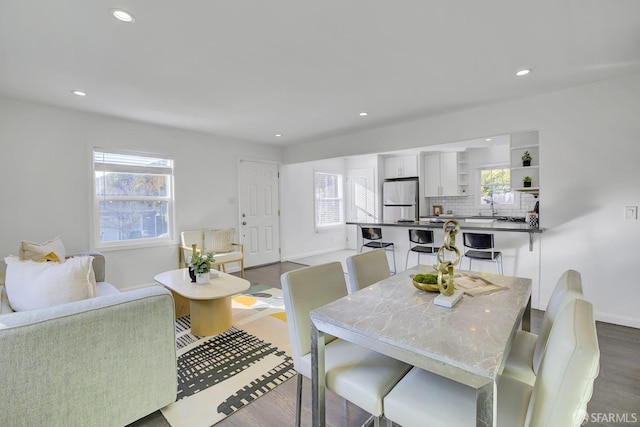 dining room with wood finished floors, baseboards, and recessed lighting