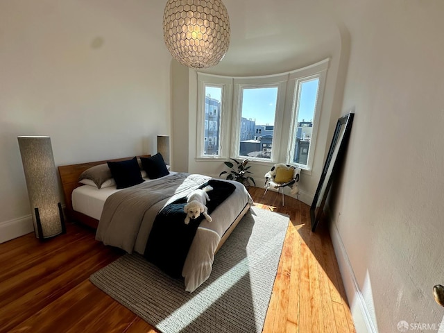 bedroom with dark wood-type flooring