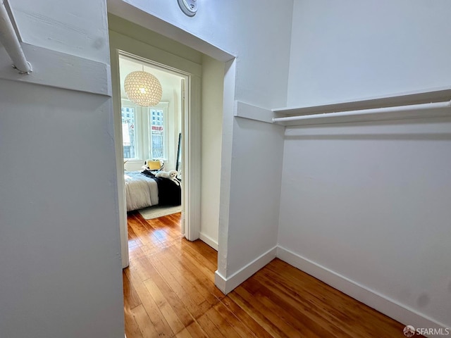 hall with hardwood / wood-style floors