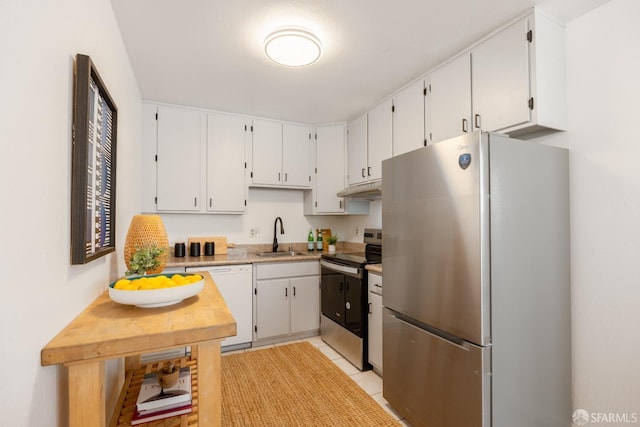 kitchen featuring light tile patterned flooring, appliances with stainless steel finishes, sink, and white cabinets