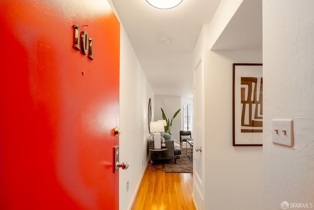 hallway with hardwood / wood-style floors