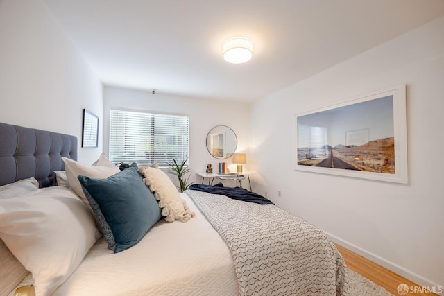 bedroom with hardwood / wood-style floors