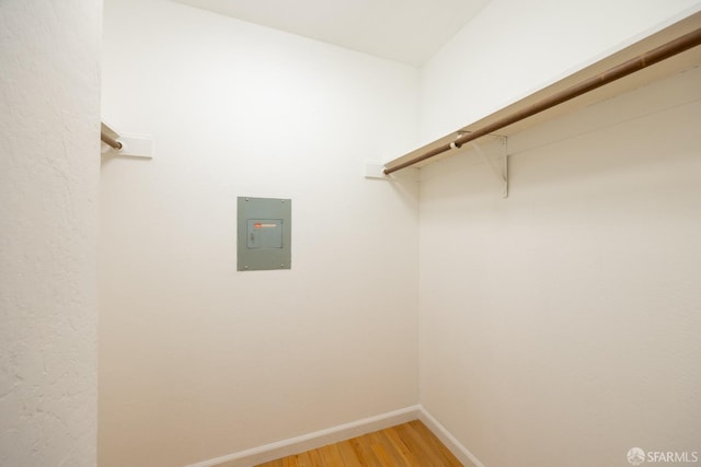 walk in closet with wood-type flooring