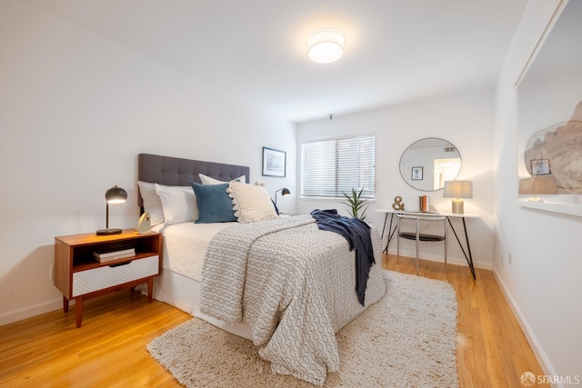 bedroom with wood-type flooring