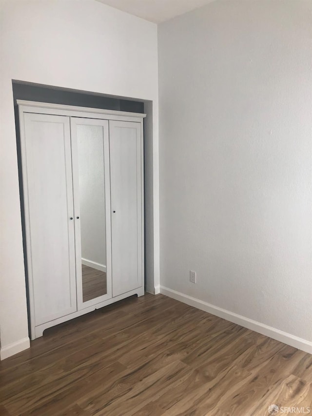 3-5 Sonoma St, San Francisco, CA 94133 - unfurnished bedroom with dark wood-type flooring, baseboards, and a closet