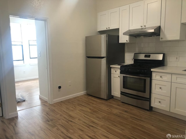 3-5 Sonoma St, San Francisco, CA 94133 - kitchen featuring under cabinet range hood, stainless steel appliances, white cabinetry, and baseboards