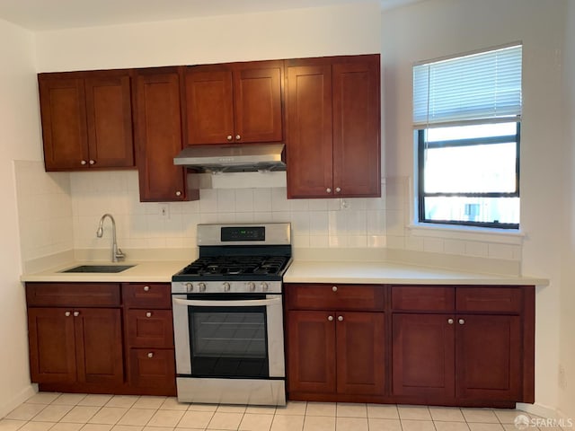 3-5 Sonoma St, San Francisco, CA 94133 - kitchen featuring stainless steel gas stove, under cabinet range hood, a sink, light countertops, and decorative backsplash
