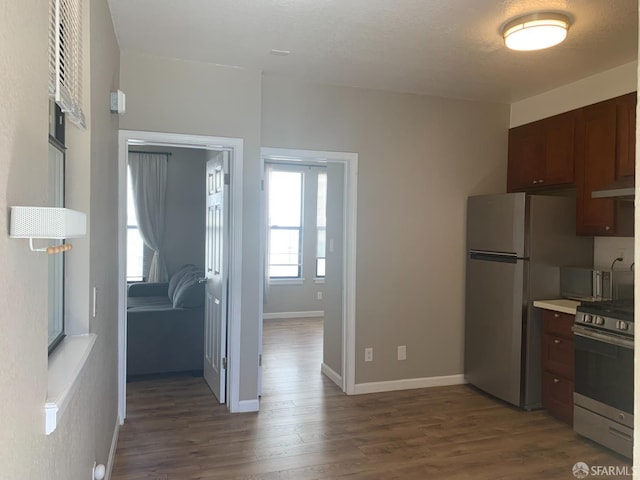 3-5 Sonoma St, San Francisco, CA 94133 - kitchen featuring stainless steel appliances, dark wood-style flooring, baseboards, light countertops, and under cabinet range hood