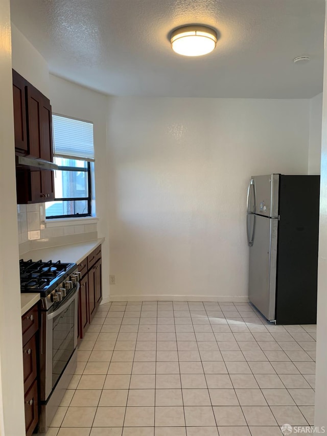 3-5 Sonoma St, San Francisco, CA 94133 - kitchen featuring appliances with stainless steel finishes, light countertops, dark brown cabinets, a textured ceiling, and baseboards