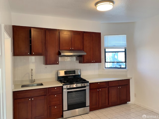 3-5 Sonoma St, San Francisco, CA 94133 - kitchen with stainless steel gas range, under cabinet range hood, a sink, light countertops, and backsplash