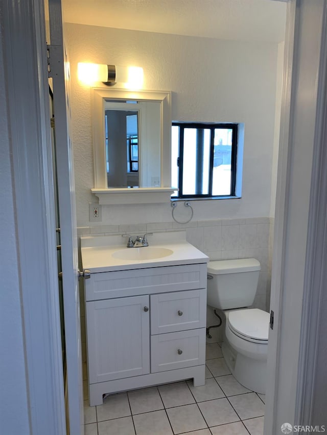 3-5 Sonoma St, San Francisco, CA 94133 - bathroom featuring tile patterned flooring, toilet, vanity, a wainscoted wall, and tile walls