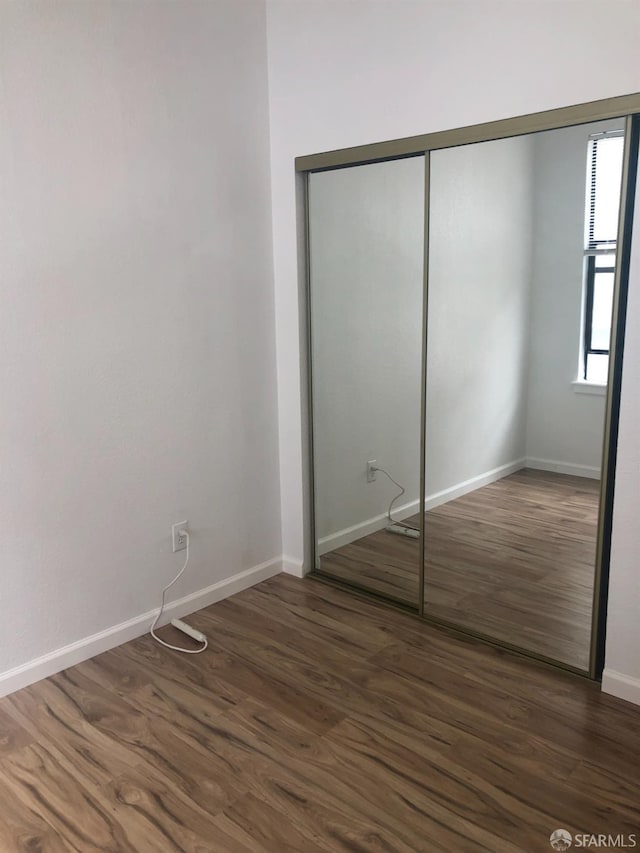 3-5 Sonoma St, San Francisco, CA 94133 - unfurnished bedroom featuring dark wood-type flooring, baseboards, and a closet