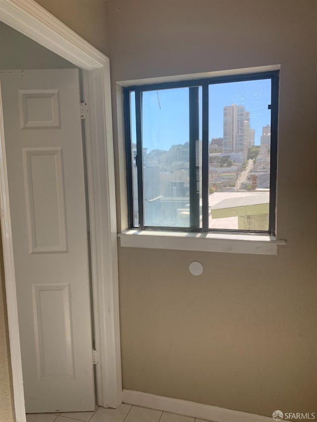 3-5 Sonoma St, San Francisco, CA 94133 - spare room with light tile patterned floors, baseboards, and a city view
