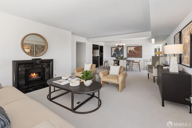 living room with light carpet, a chandelier, and a premium fireplace