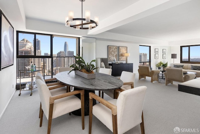 carpeted dining area featuring a city view, baseboards, and an inviting chandelier