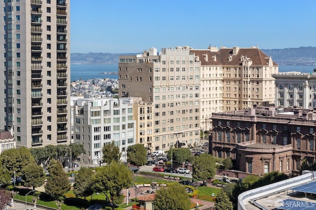 view of property with a city view and a water view