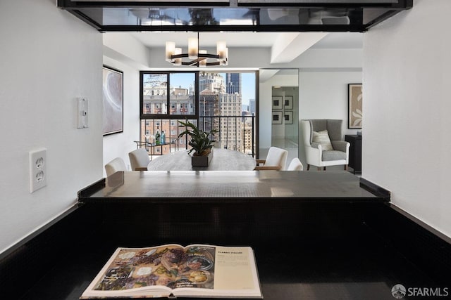 dining area with a view of city and a chandelier