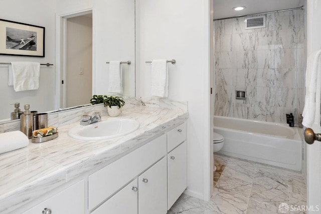 bathroom featuring visible vents, toilet, marble finish floor, bathing tub / shower combination, and vanity