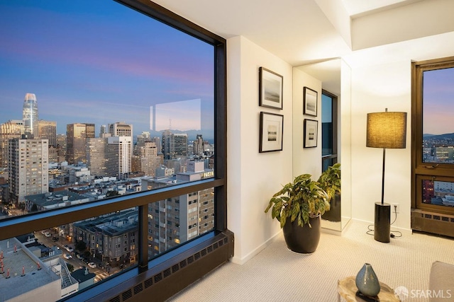 corridor with expansive windows, baseboards, a city view, and carpet flooring