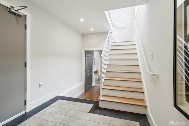 staircase with tile patterned flooring, recessed lighting, and baseboards