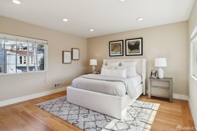 bedroom featuring light wood-type flooring, recessed lighting, and baseboards