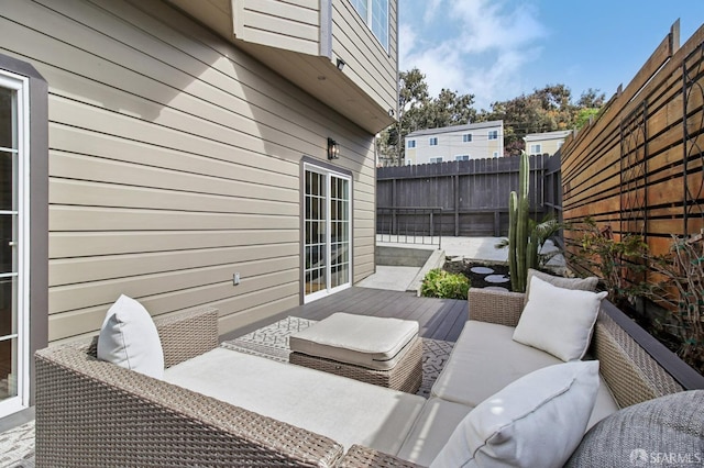 view of patio / terrace with a fenced backyard, outdoor lounge area, and a wooden deck