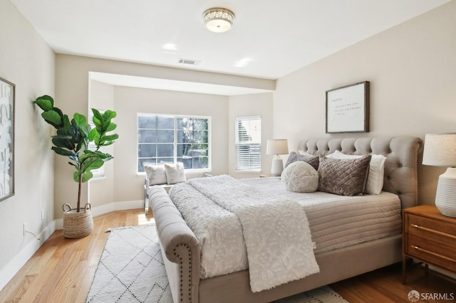 bedroom featuring light wood-style flooring and baseboards