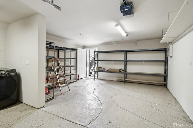 garage with a garage door opener and washer / clothes dryer
