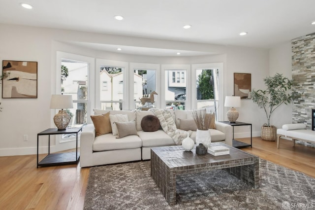 living area featuring wood finished floors, baseboards, and recessed lighting