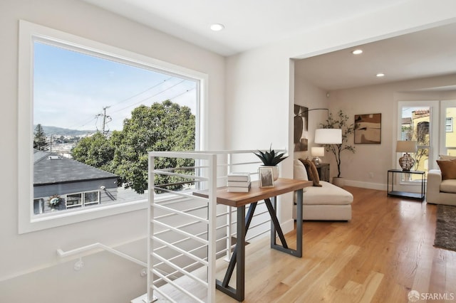interior space with plenty of natural light, light wood-style flooring, baseboards, and recessed lighting