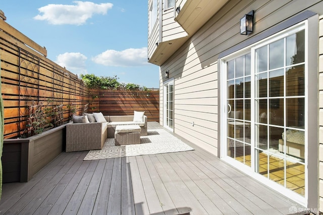 deck with an outdoor hangout area and a fenced backyard