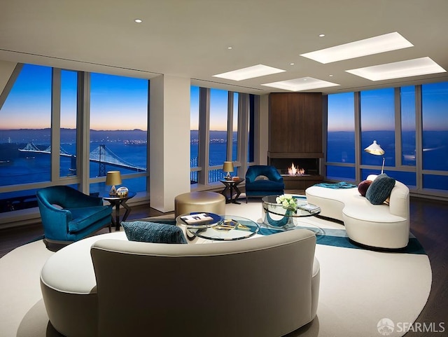 living room featuring a water view and expansive windows