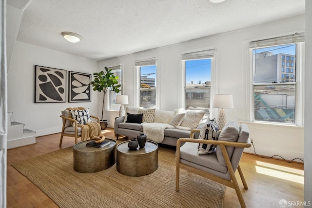 32-34 Gough St, San Francisco, CA 94103 - living room with wood finished floors, baseboards, and a textured ceiling