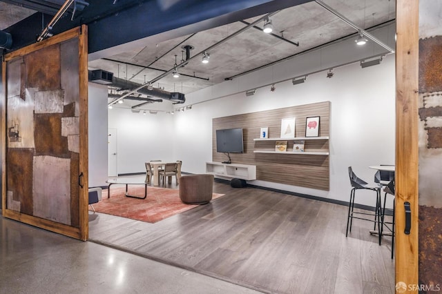 interior space with rail lighting and wood finished floors