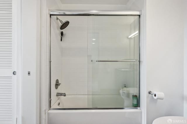 full bathroom featuring combined bath / shower with glass door, a closet, and toilet