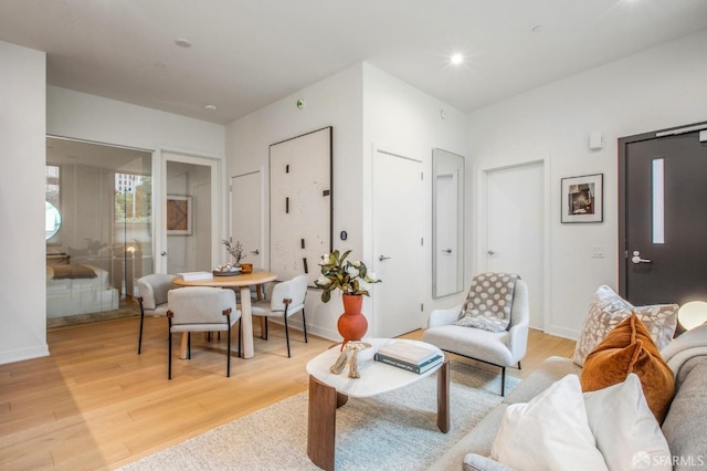 living area with light wood finished floors, recessed lighting, and baseboards