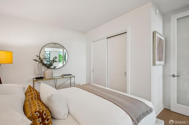 bedroom with a closet and wood finished floors