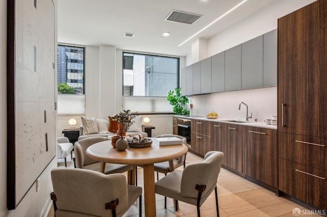 kitchen with modern cabinets, visible vents, light countertops, and a sink