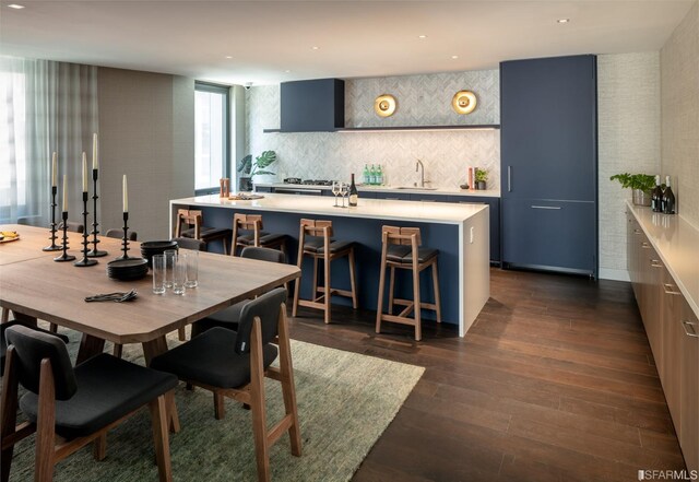 dining area with sink and dark hardwood / wood-style flooring