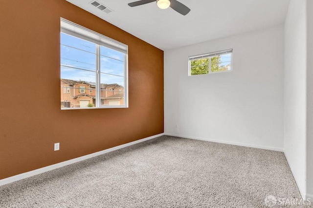 carpeted spare room with ceiling fan