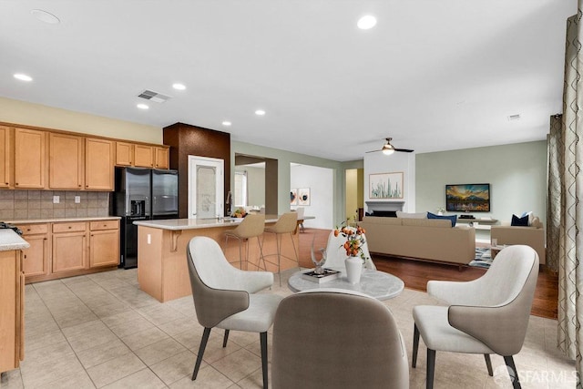 dining room featuring light tile patterned floors and ceiling fan