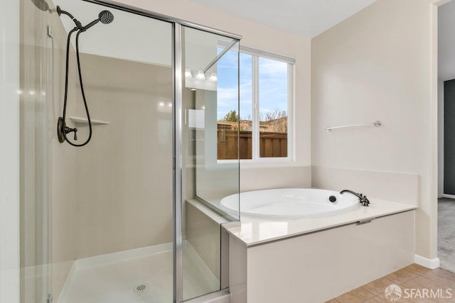 bathroom with separate shower and tub and tile patterned floors