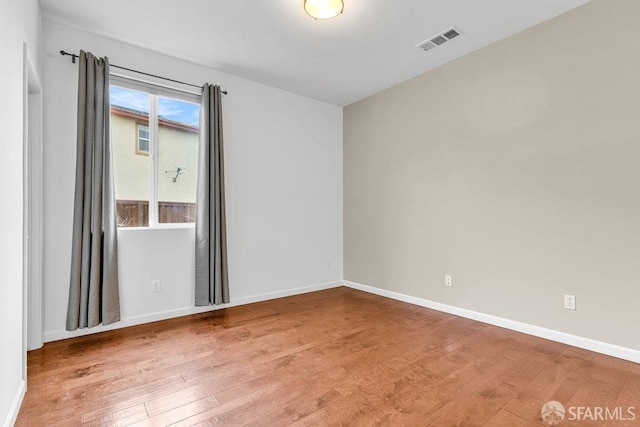 spare room featuring hardwood / wood-style flooring