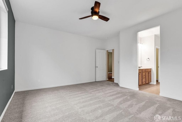 unfurnished room featuring light carpet and ceiling fan