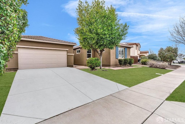 view of front of property featuring a garage and a front yard