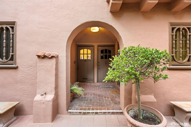 doorway to property with stucco siding