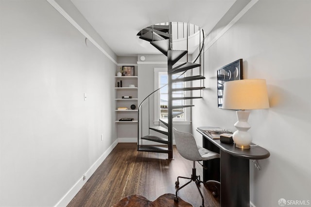 staircase with wood finished floors and baseboards